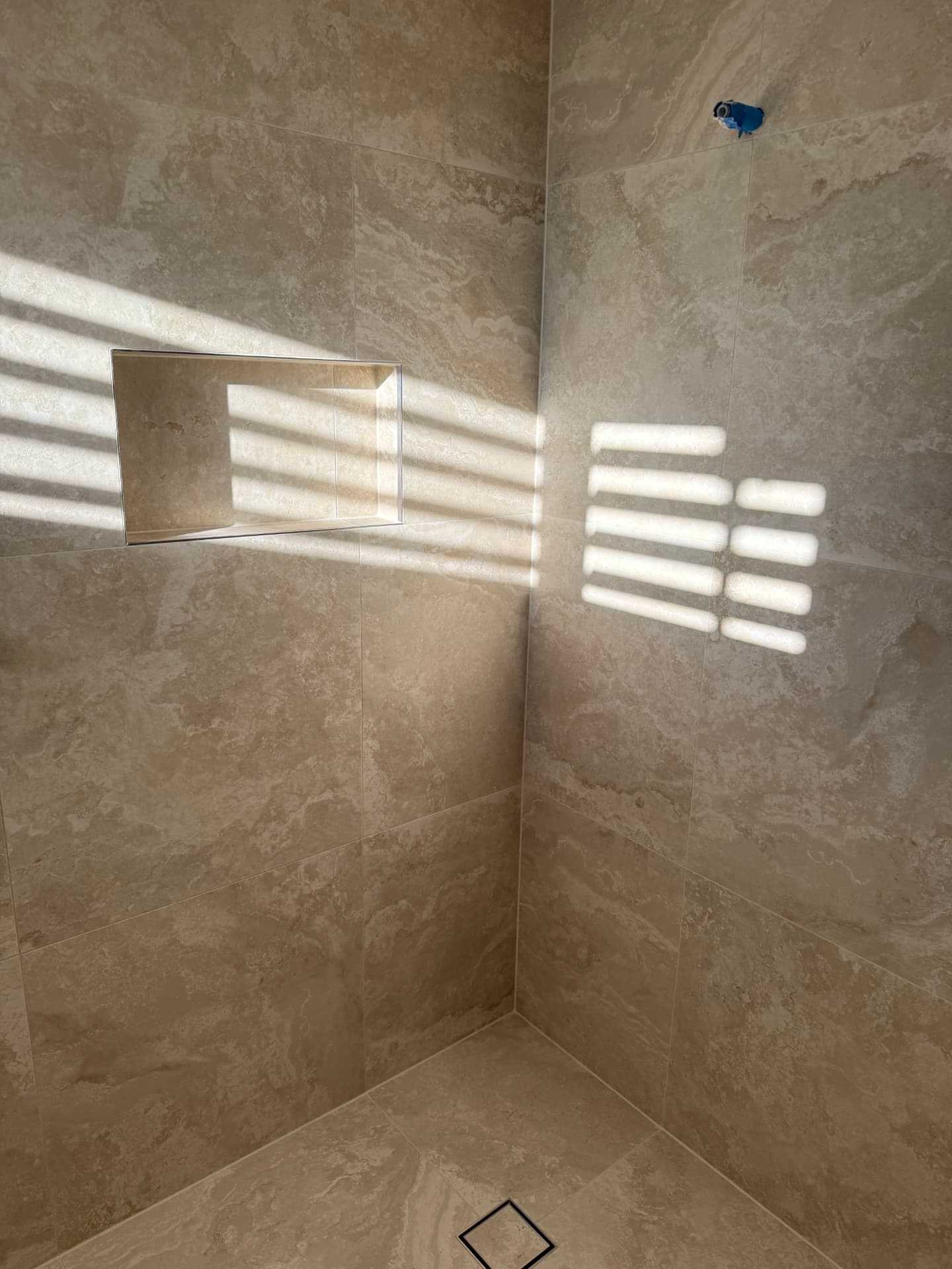 Tiled shower floor running to a linear drain