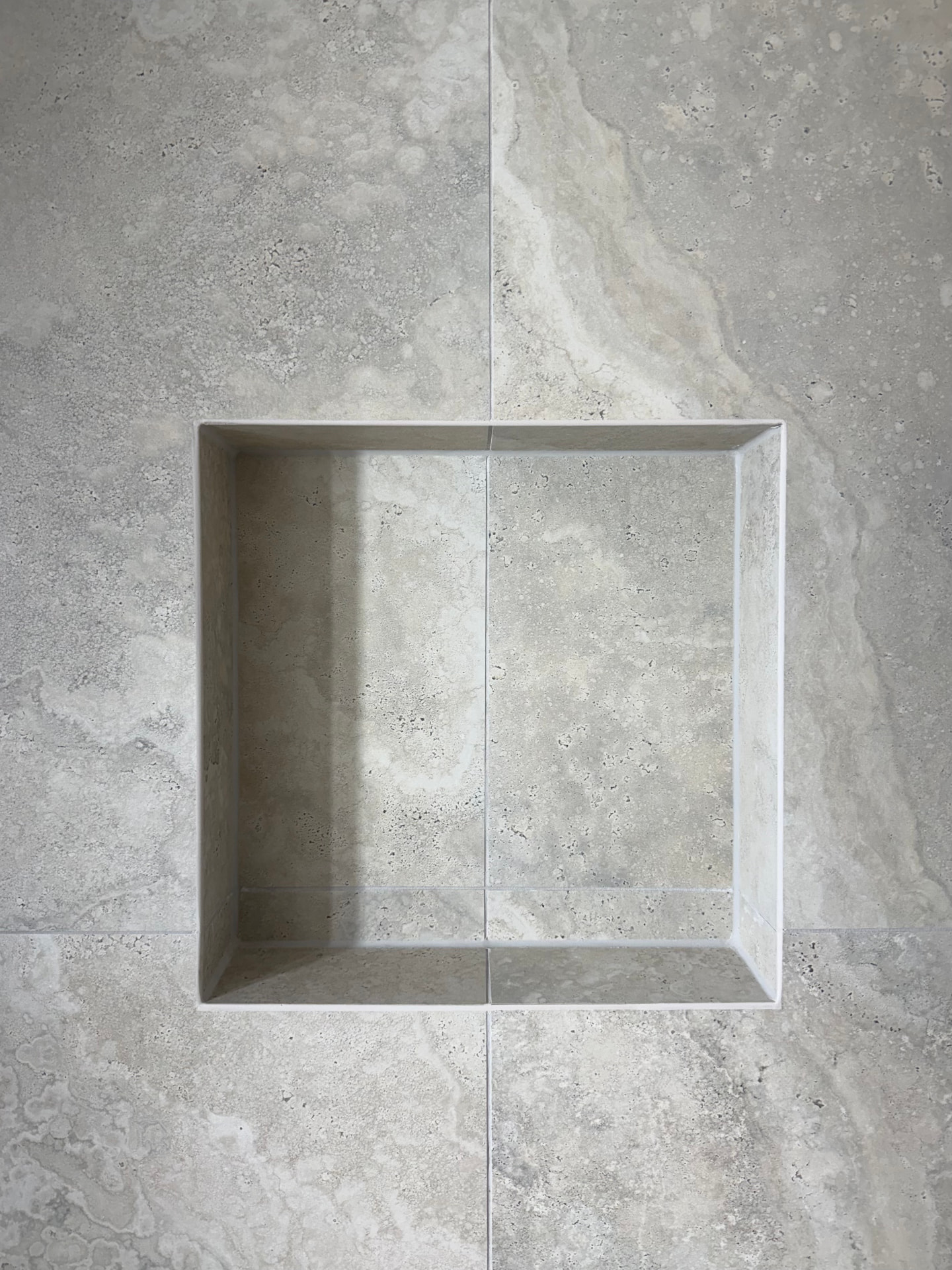 Close-up of a tiled niche with a clean mitred edge