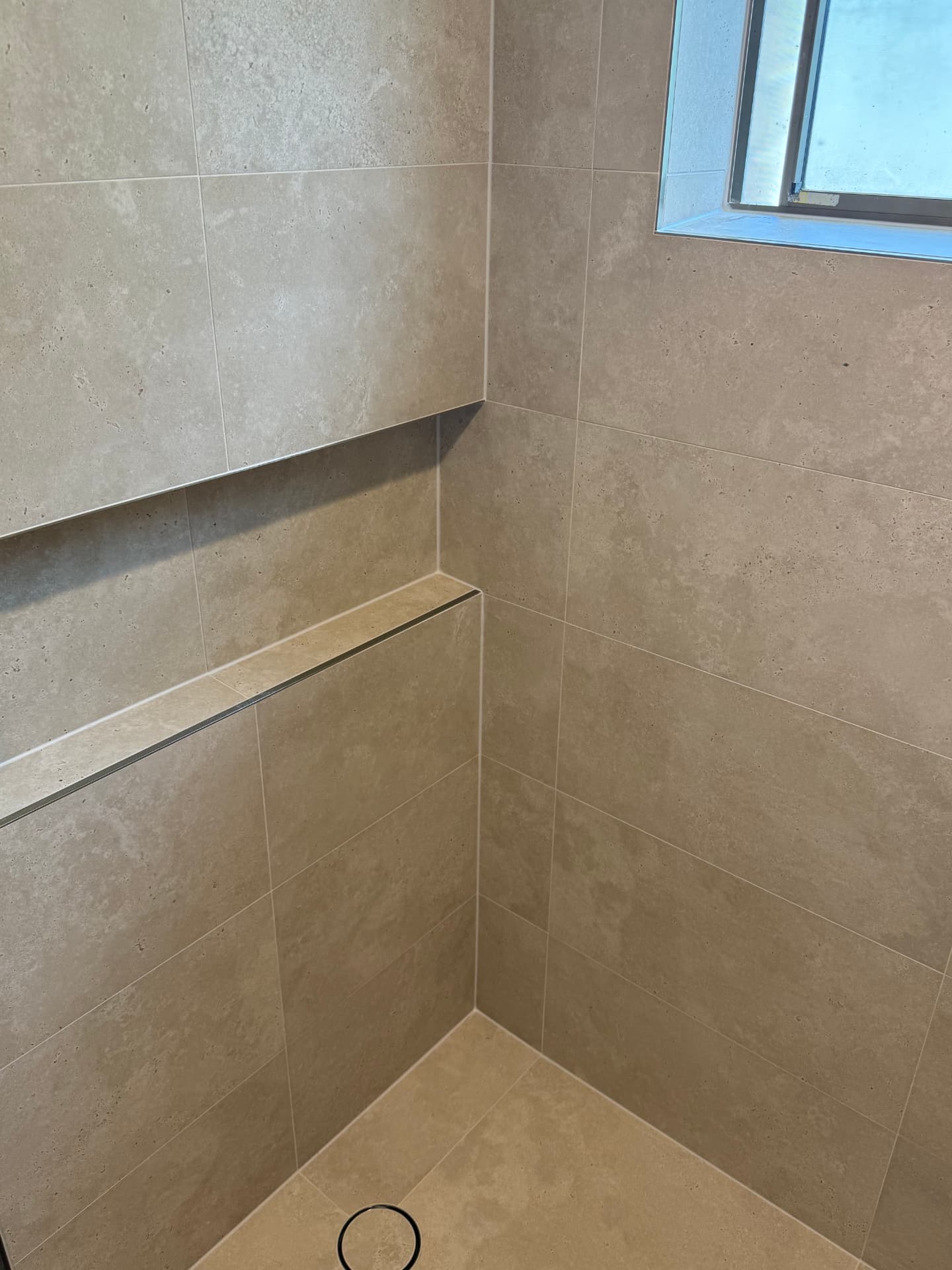 Tiled corner with a recessed shelf detail